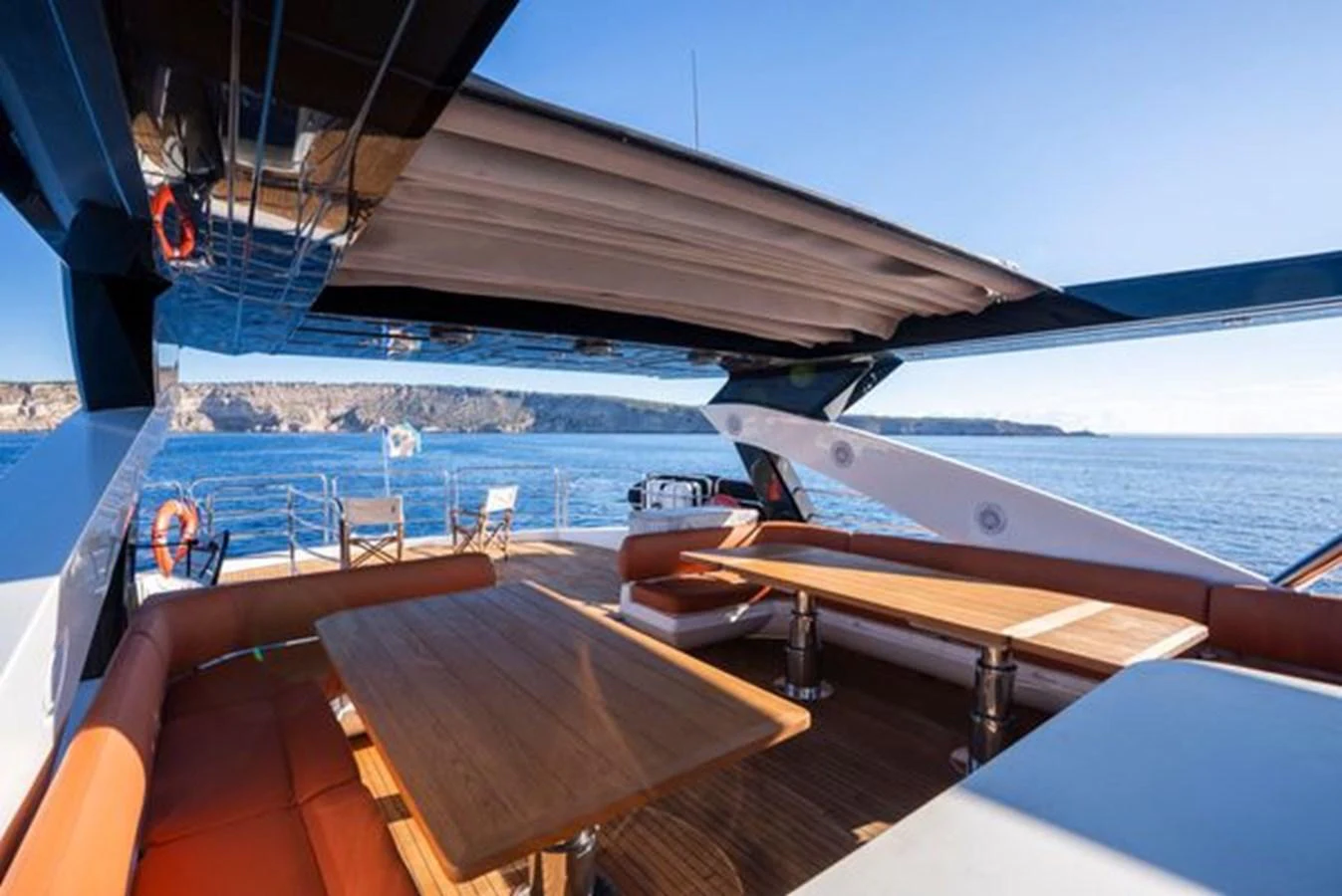 The flybridge offers a spacious and comfortable outdoor seating area with stunning ocean views. aboard 2015 SUNSEEKER 28M RIII Yacht for Sale