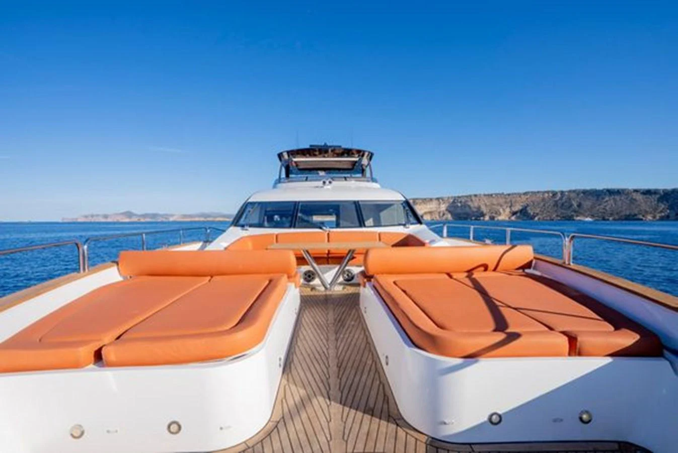 The yacht's foredeck features spacious sun loungers with stunning ocean views. aboard 2015 SUNSEEKER 28M RIII Yacht for Sale