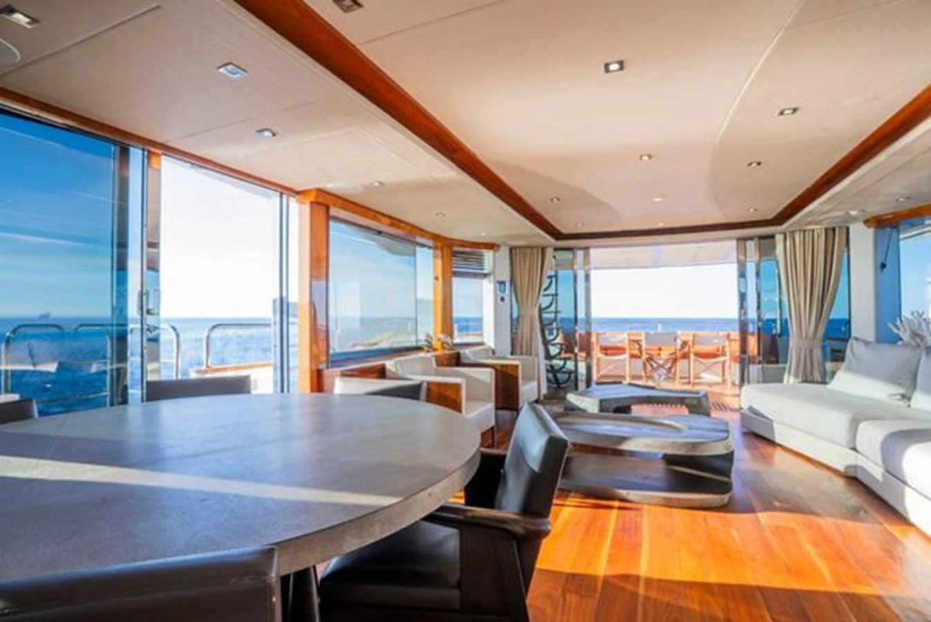 The salon features expansive windows, modern furnishings, and a seamless transition to the aft deck. aboard 2015 SUNSEEKER 28M RIII Yacht for Sale