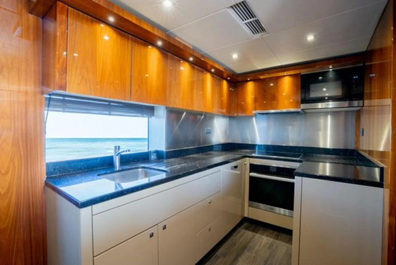 The galley features sleek cabinetry, modern appliances, and ample counter space. aboard 2015 SUNSEEKER 28M RIII Yacht for Sale