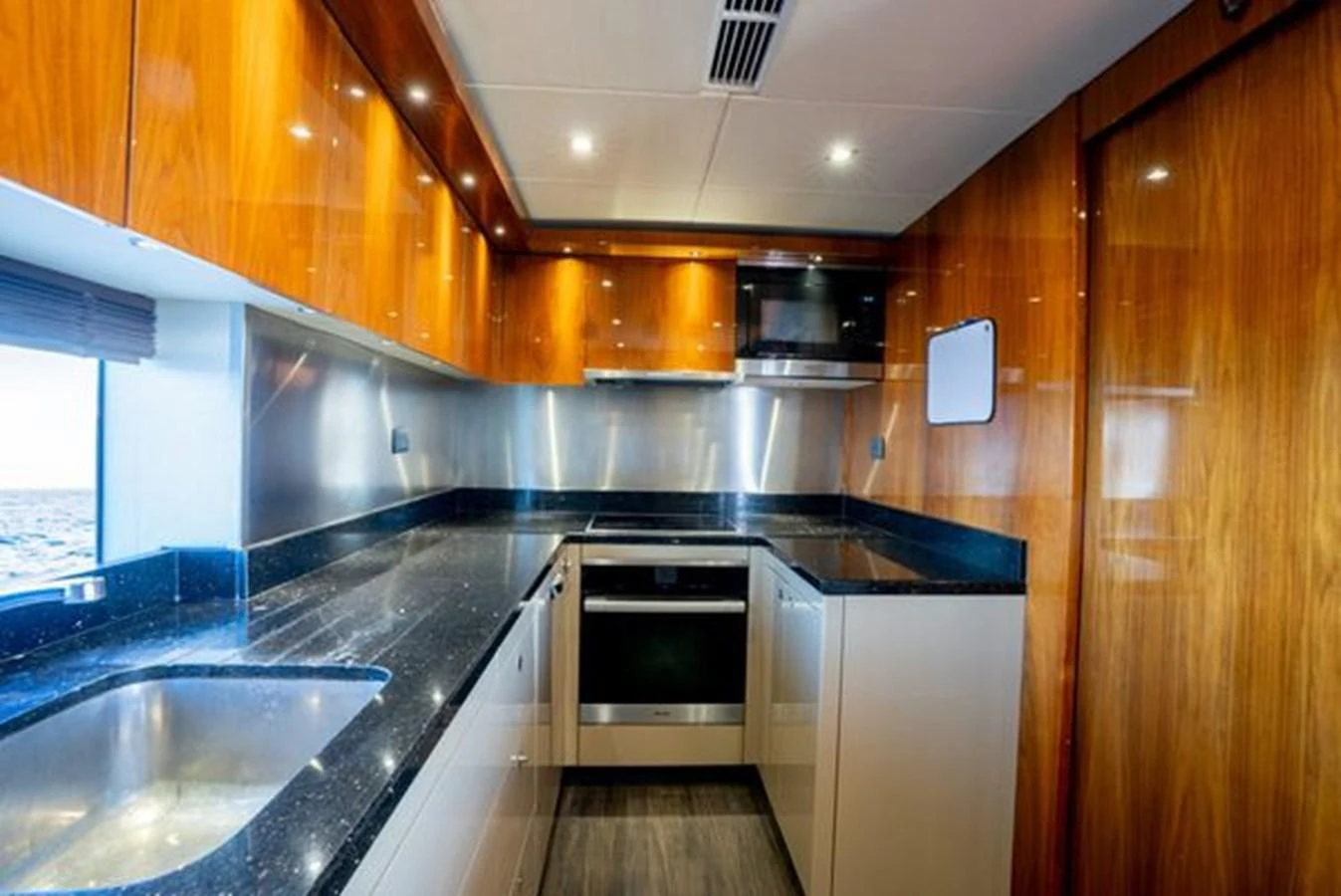 The yacht's galley features sleek countertops and modern appliances, creating a stylish and functional space. aboard 2015 SUNSEEKER 28M RIII Yacht for Sale