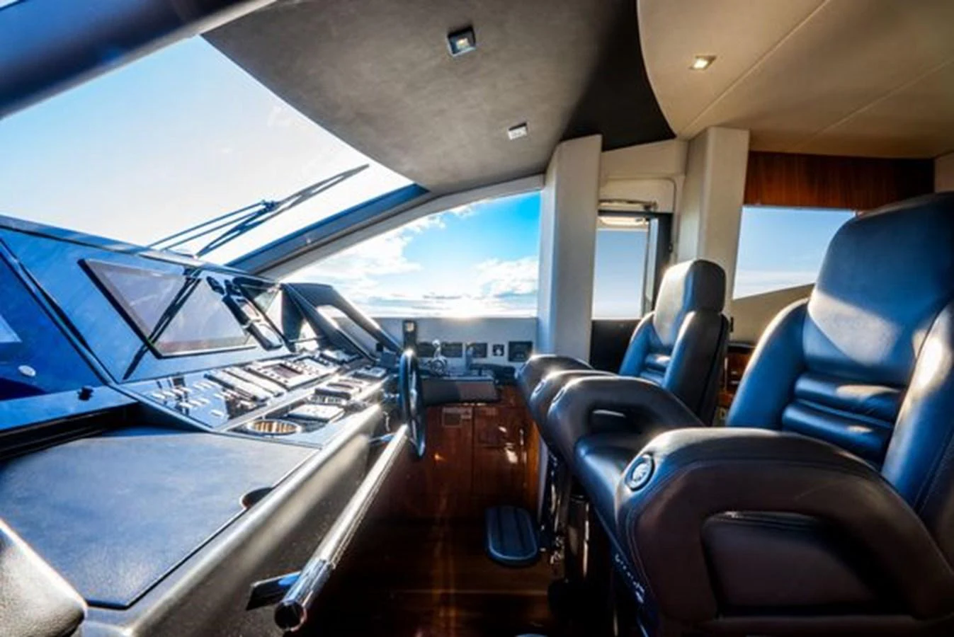 The helm features modern controls and comfortable seating with a panoramic view. aboard 2015 SUNSEEKER 28M RIII Yacht for Sale