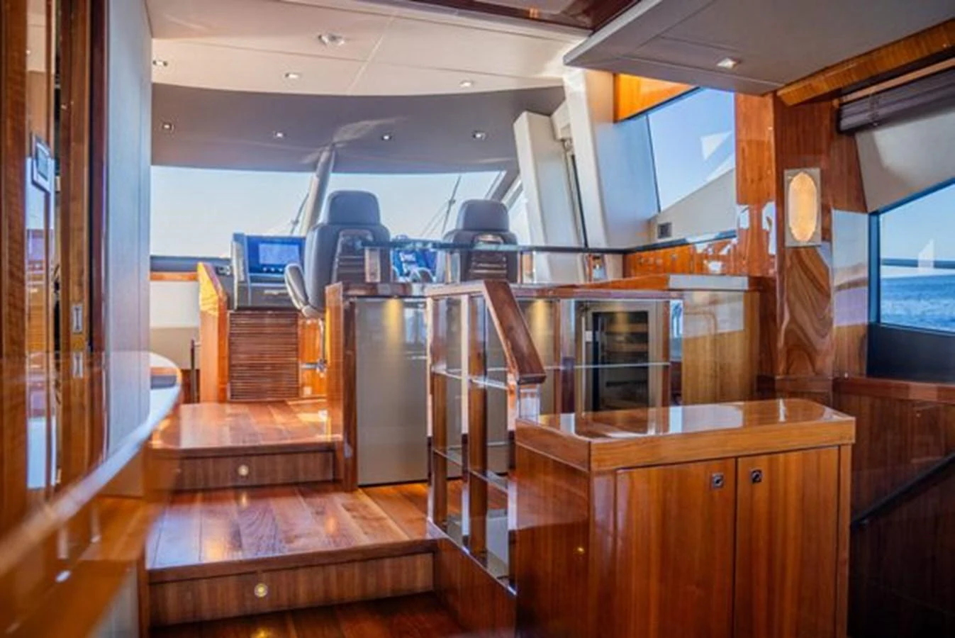 The yacht's helm area features luxurious wood finishes and modern navigation equipment. aboard 2015 SUNSEEKER 28M RIII Yacht for Sale