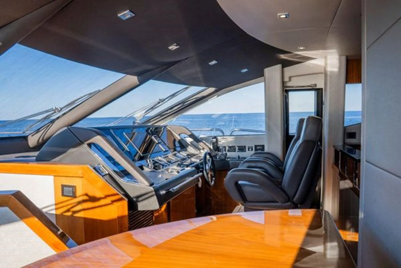 The helm station offers a sleek and modern design with expansive views of the ocean. aboard 2015 SUNSEEKER 28M RIII Yacht for Sale