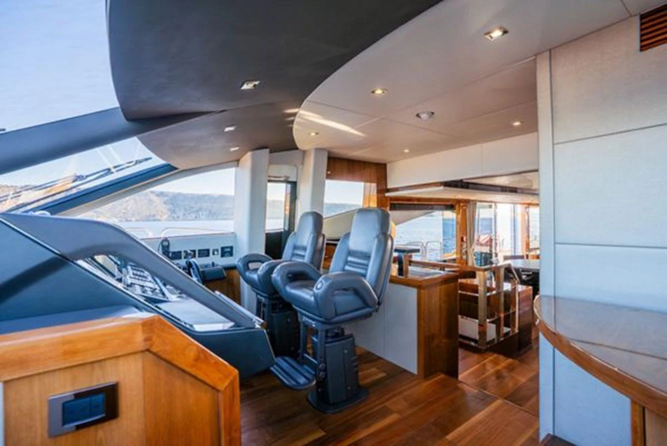 The helm station features luxurious seating and a panoramic view, blending functionality with comfort. aboard 2015 SUNSEEKER 28M RIII Yacht for Sale