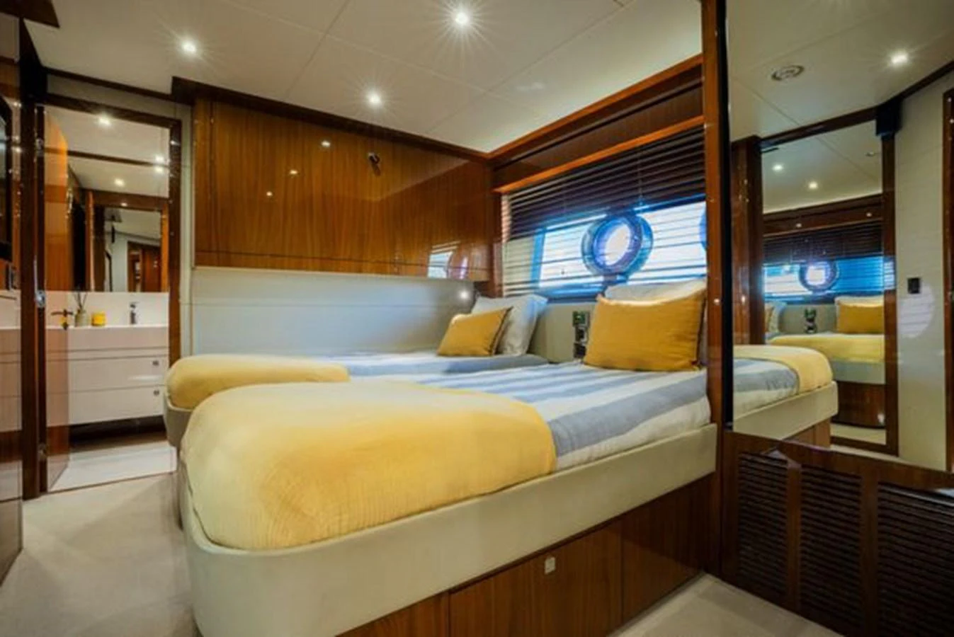 The guest stateroom features twin beds with luxurious bedding and warm wood finishes. aboard 2015 SUNSEEKER 28M RIII Yacht for Sale