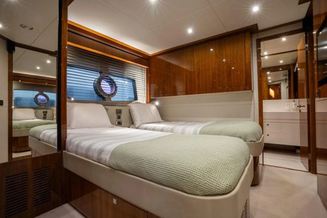 The guest cabin features twin beds with elegant bedding and warm wood finishes. aboard 2015 SUNSEEKER 28M RIII Yacht for Sale