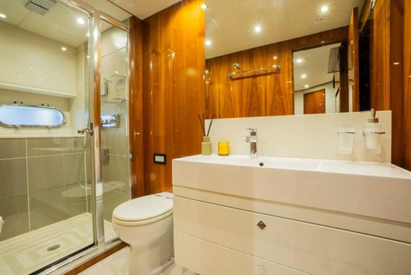 The yacht's bathroom features a sleek design with modern fixtures and warm wood accents. aboard 2015 SUNSEEKER 28M RIII Yacht for Sale