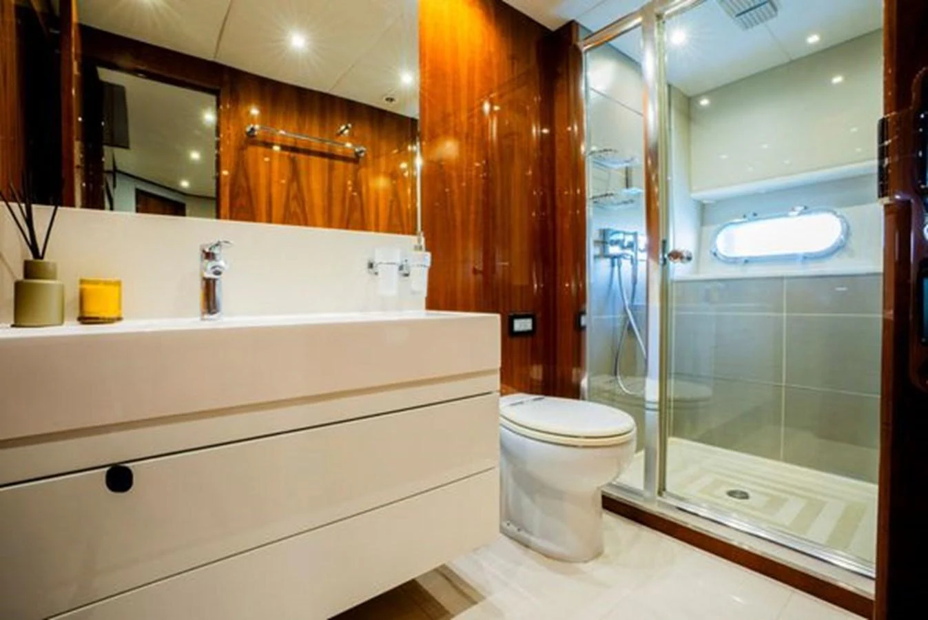 A luxurious yacht bathroom featuring modern fixtures and elegant wood paneling. aboard 2015 SUNSEEKER 28M RIII Yacht for Sale