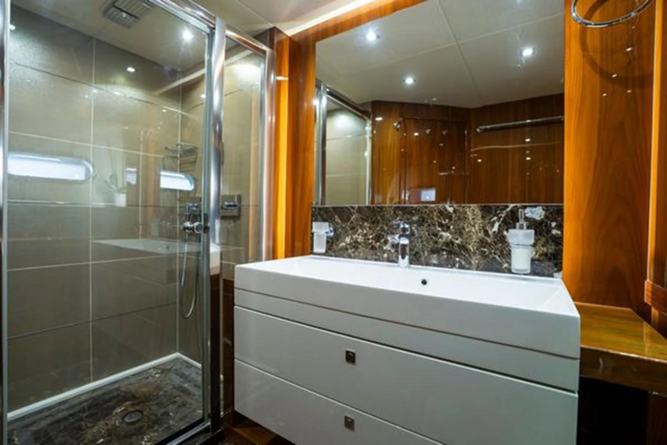 The yacht's bathroom features a sleek design with a spacious shower and elegant fixtures. aboard 2015 SUNSEEKER 28M RIII Yacht for Sale