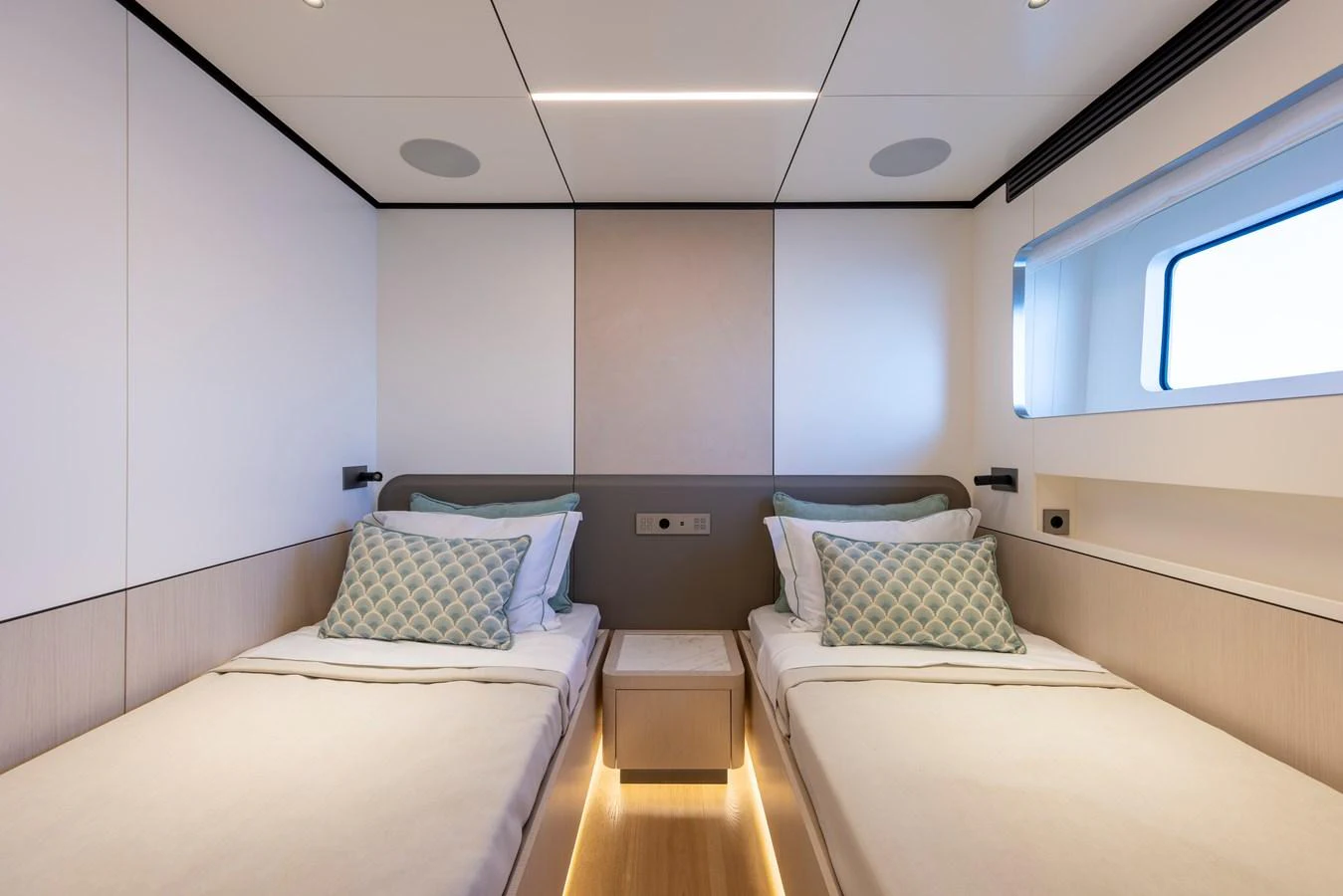The twin stateroom features modern design with two single beds and elegant lighting. aboard BEE EXPLORER YACHT Yacht for Sale