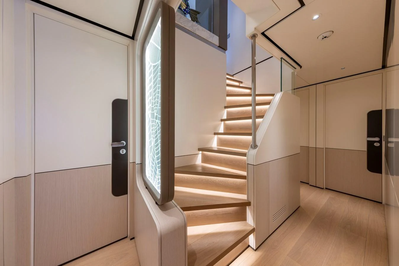 A modern yacht interior featuring a sleek, well-lit staircase with elegant design elements. aboard BEE EXPLORER YACHT Yacht for Sale