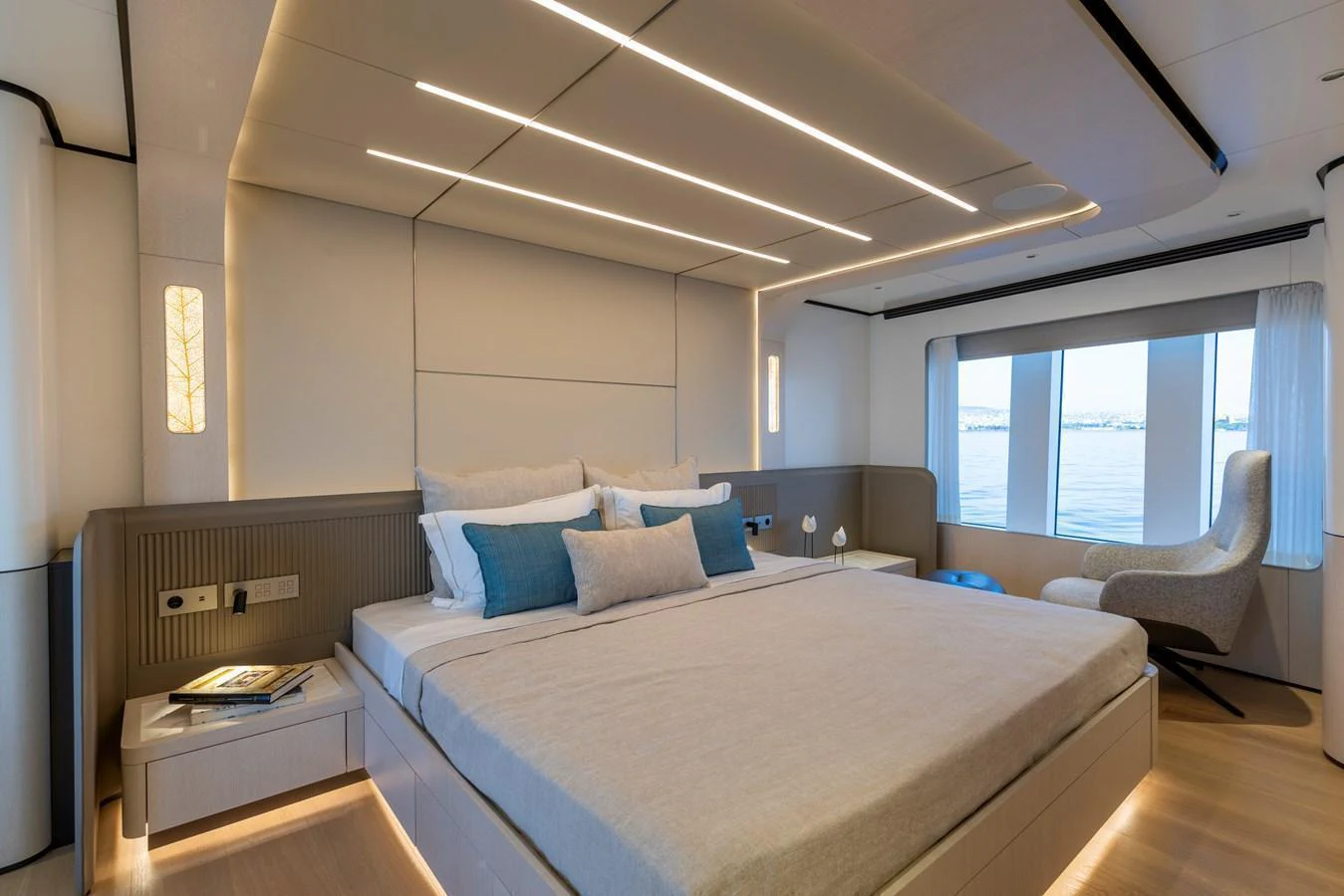 The master stateroom features a luxurious bed with modern lighting and large windows offering stunning views. aboard BEE EXPLORER YACHT Yacht for Sale
