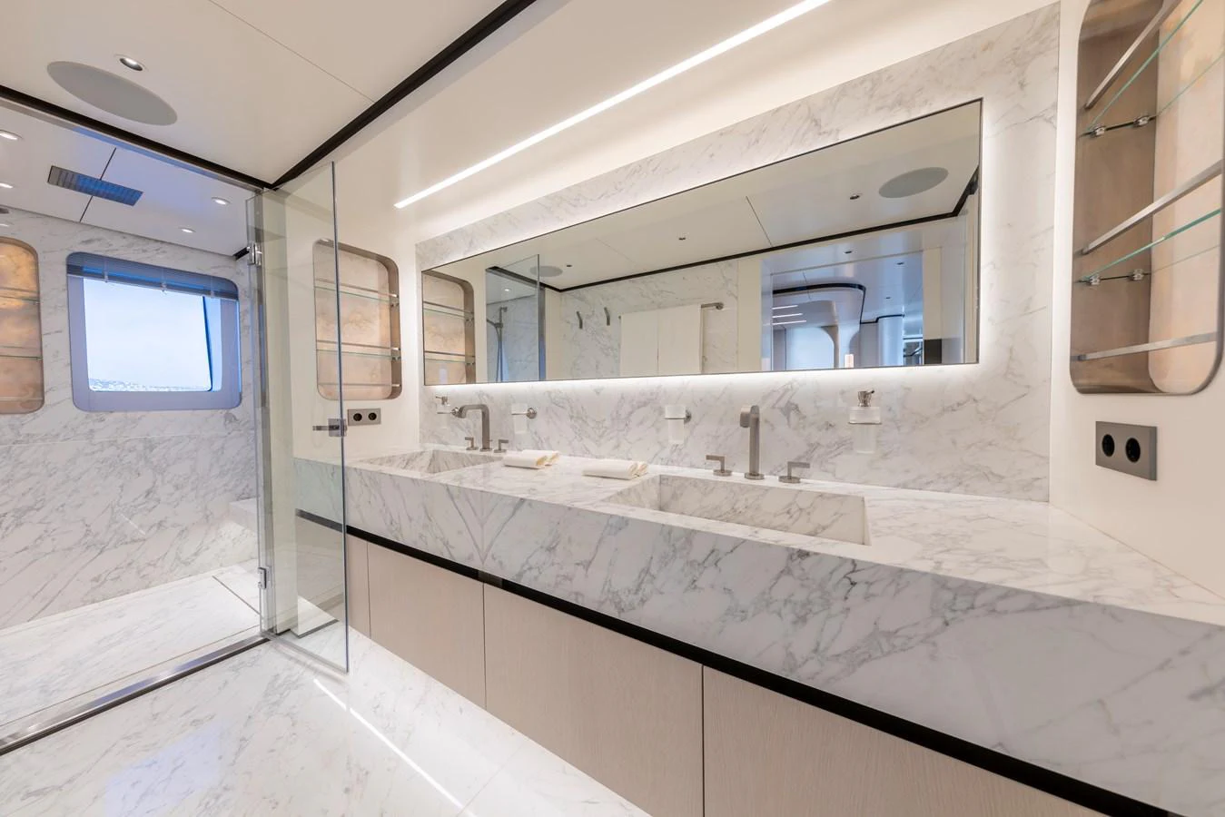 The yacht's bathroom features a luxurious marble finish with dual sinks and modern fixtures. aboard BEE EXPLORER YACHT Yacht for Sale