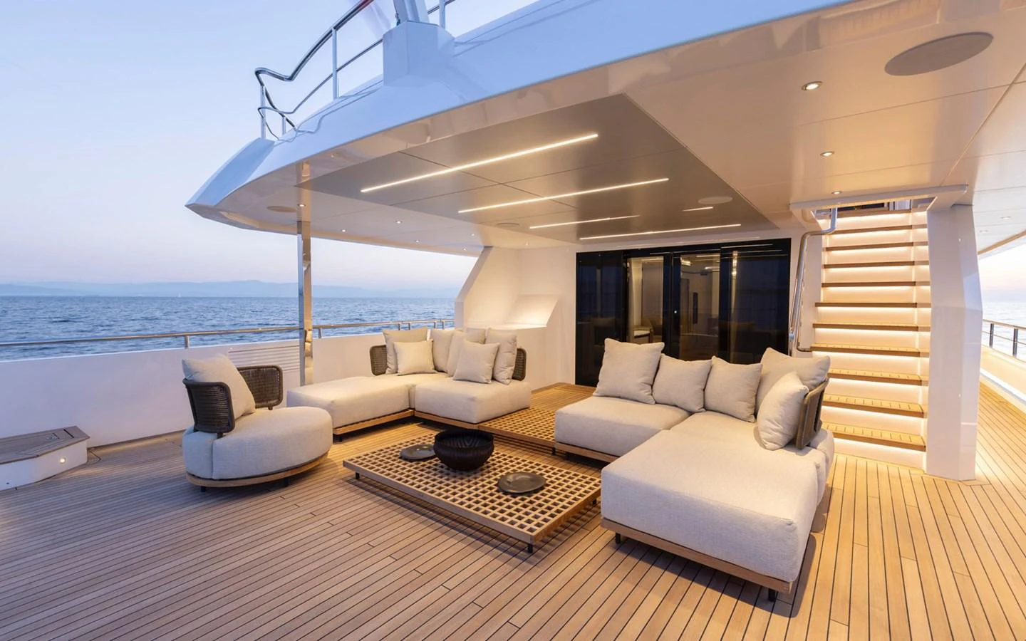 The aft deck offers a luxurious and spacious lounging area with comfortable seating and elegant lighting. aboard BEE EXPLORER YACHT Yacht for Sale