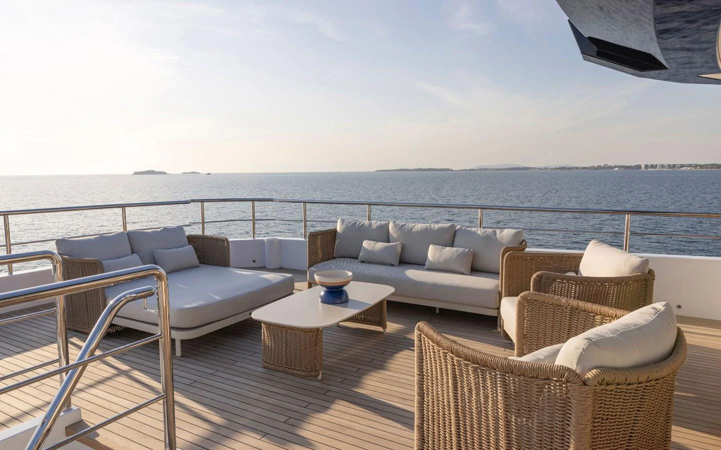 The aft deck features a luxurious outdoor seating area with comfortable sofas and a stunning sea view. aboard BEE EXPLORER YACHT Yacht for Sale