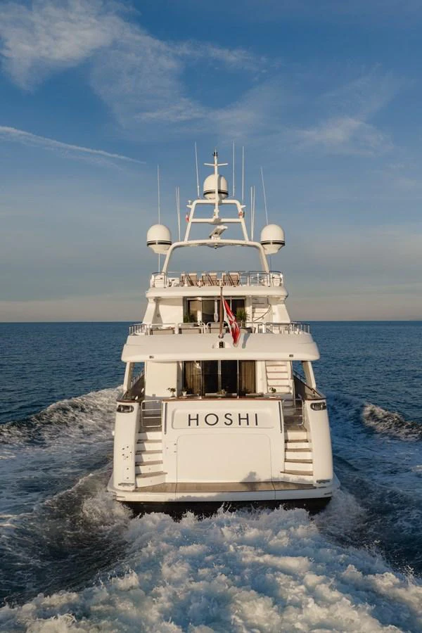 A luxurious yacht cruises through the open sea, showcasing its sleek design and elegant structure. aboard HOSHI Yacht for Sale