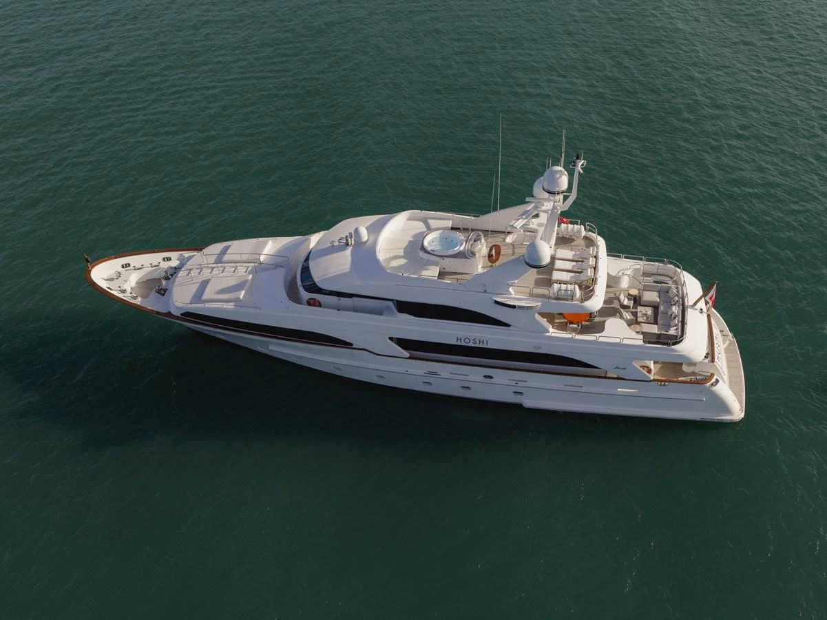 A sleek and elegant yacht cruising on calm waters, showcasing its luxurious design and spacious decks. aboard HOSHI Yacht for Sale
