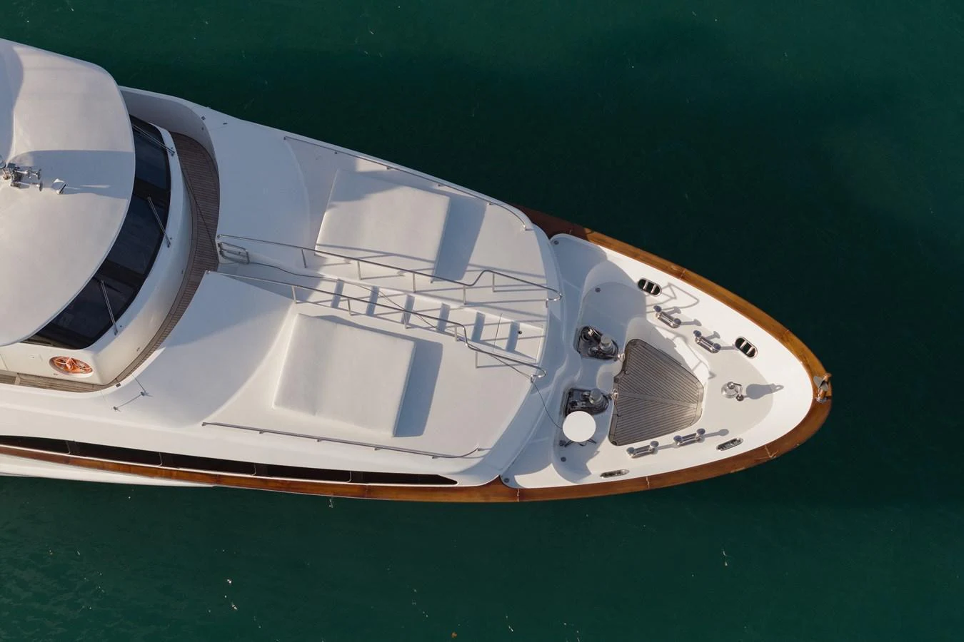The foredeck of the yacht features spacious sun pads and sleek design elements, perfect for relaxation. aboard HOSHI Yacht for Sale