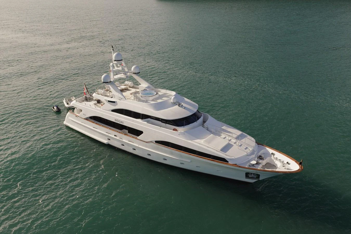A stunning yacht glides gracefully on calm waters, showcasing its sleek design and luxurious features. aboard HOSHI Yacht for Sale