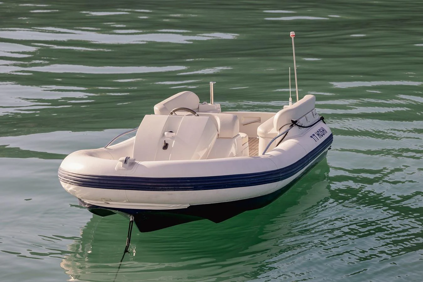 A sleek and modern tender floats calmly on serene waters. aboard HOSHI Yacht for Sale