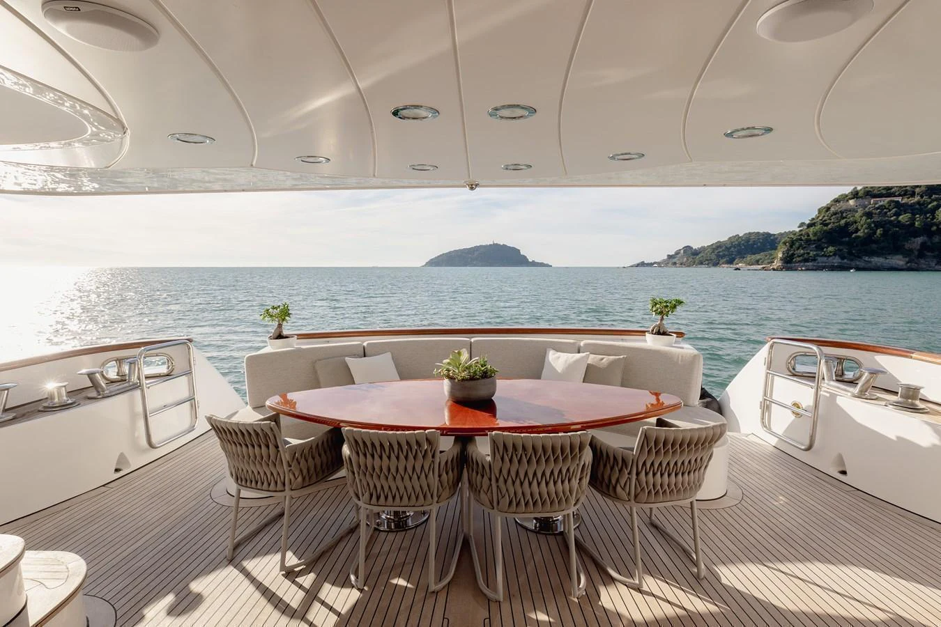 The aft deck features an elegant dining area with a stunning ocean view. aboard HOSHI Yacht for Sale