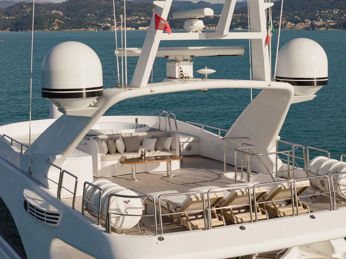 The yacht's aft deck features a spacious lounging area with plush seating and sunbeds, perfect for relaxation. aboard HOSHI Yacht for Sale
