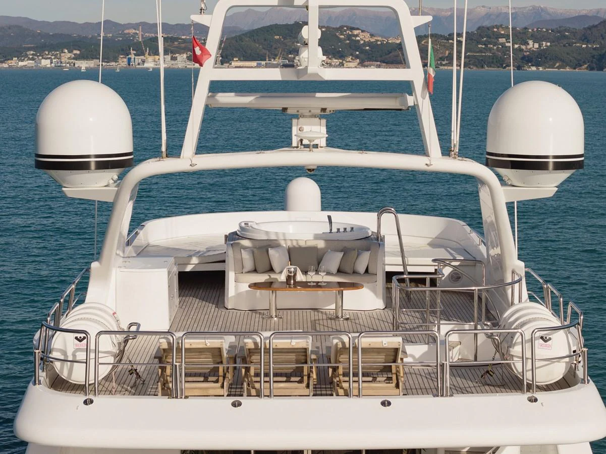 The yacht's flybridge offers a spacious and luxurious outdoor seating area with stunning views. aboard HOSHI Yacht for Sale