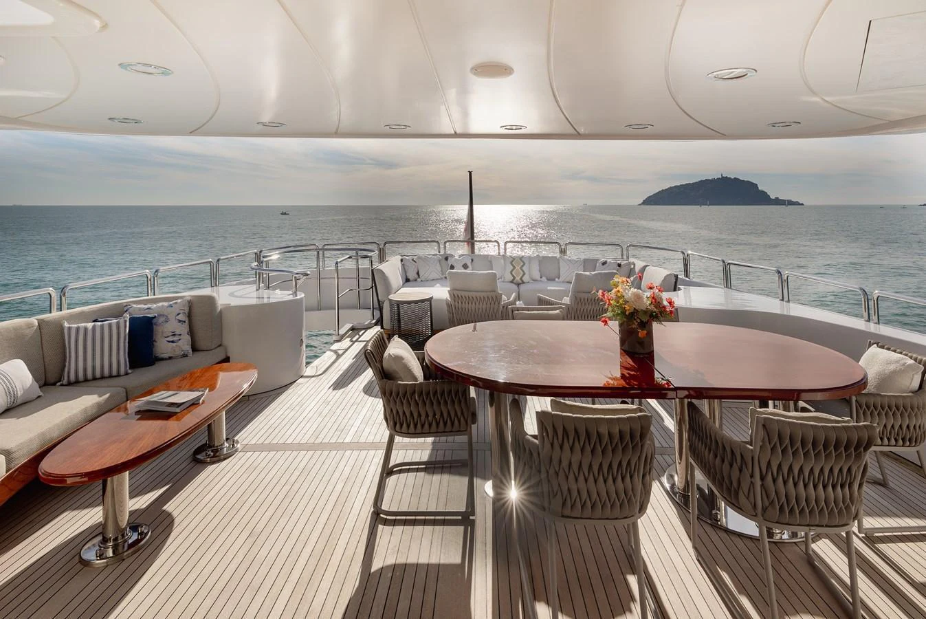 The aft deck offers a luxurious outdoor dining and lounging area with stunning sea views. aboard HOSHI Yacht for Sale