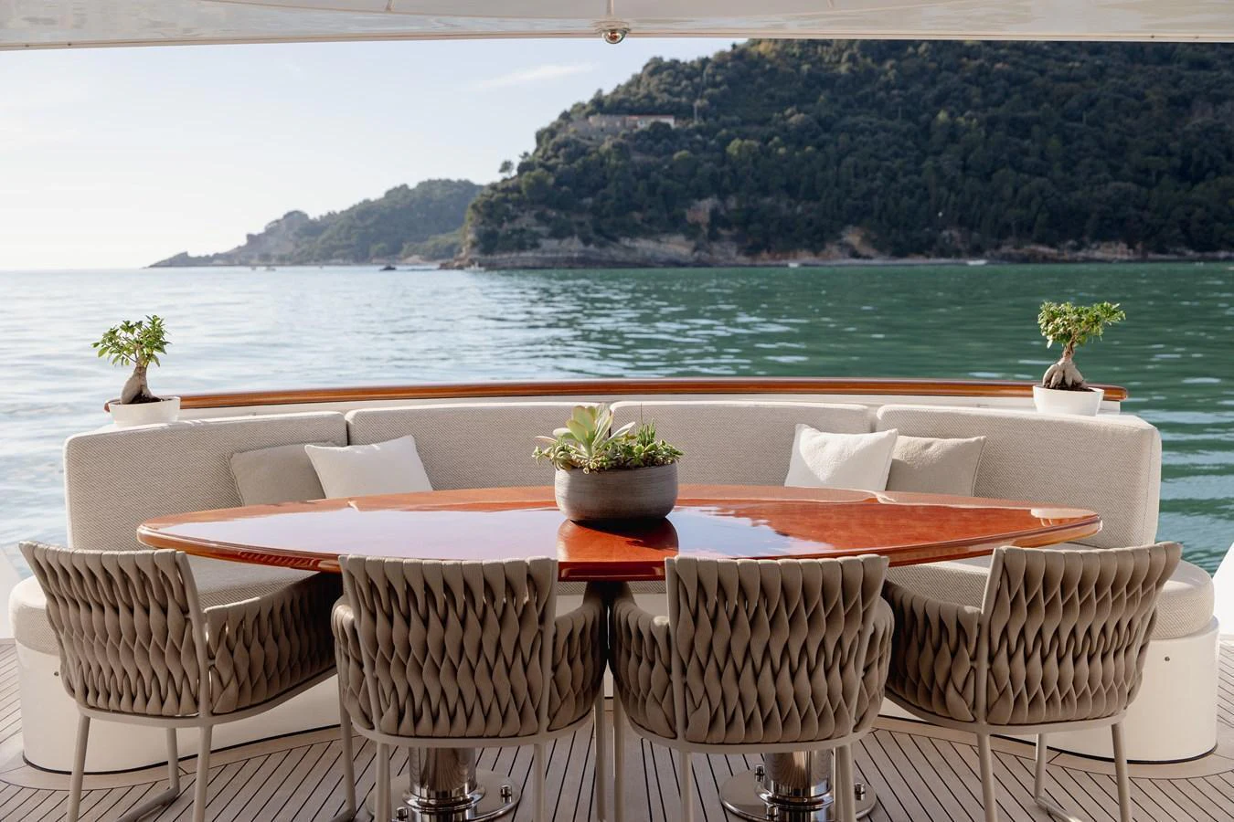 The aft deck features an elegant dining area with a stunning view of the surrounding waters. aboard HOSHI Yacht for Sale