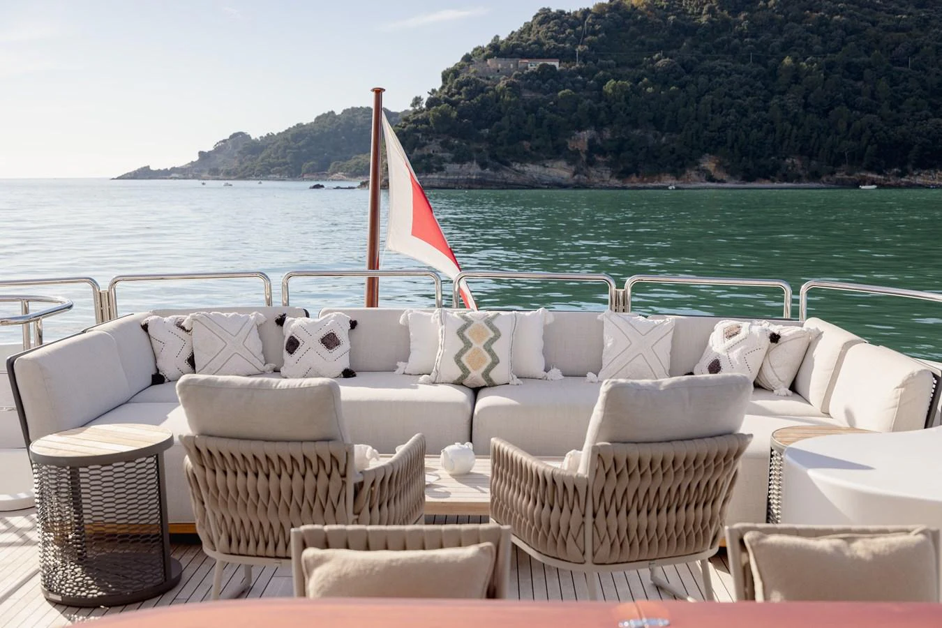 The aft deck features a comfortable seating area with a stunning view of the surrounding waters and landscape. aboard HOSHI Yacht for Sale