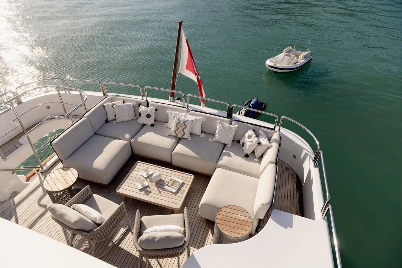 The aft deck features a spacious and comfortable seating area with a view of the serene waters. aboard HOSHI Yacht for Sale