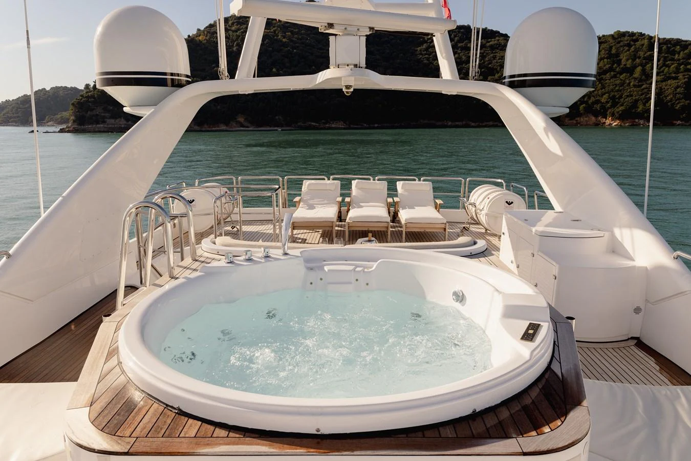The sundeck features a luxurious jacuzzi with a stunning view of the surrounding waters. aboard HOSHI Yacht for Sale