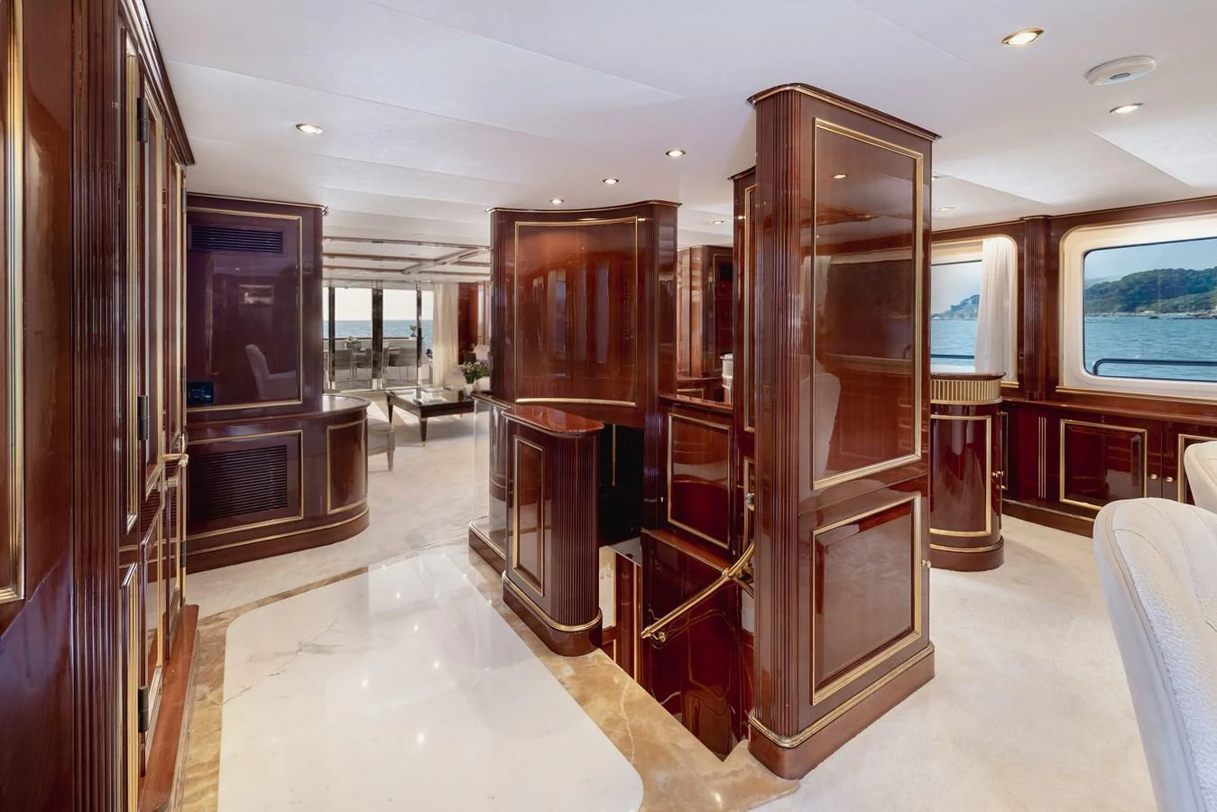 The yacht's interior features luxurious wood paneling and elegant design elements, creating a sophisticated ambiance. aboard HOSHI Yacht for Sale