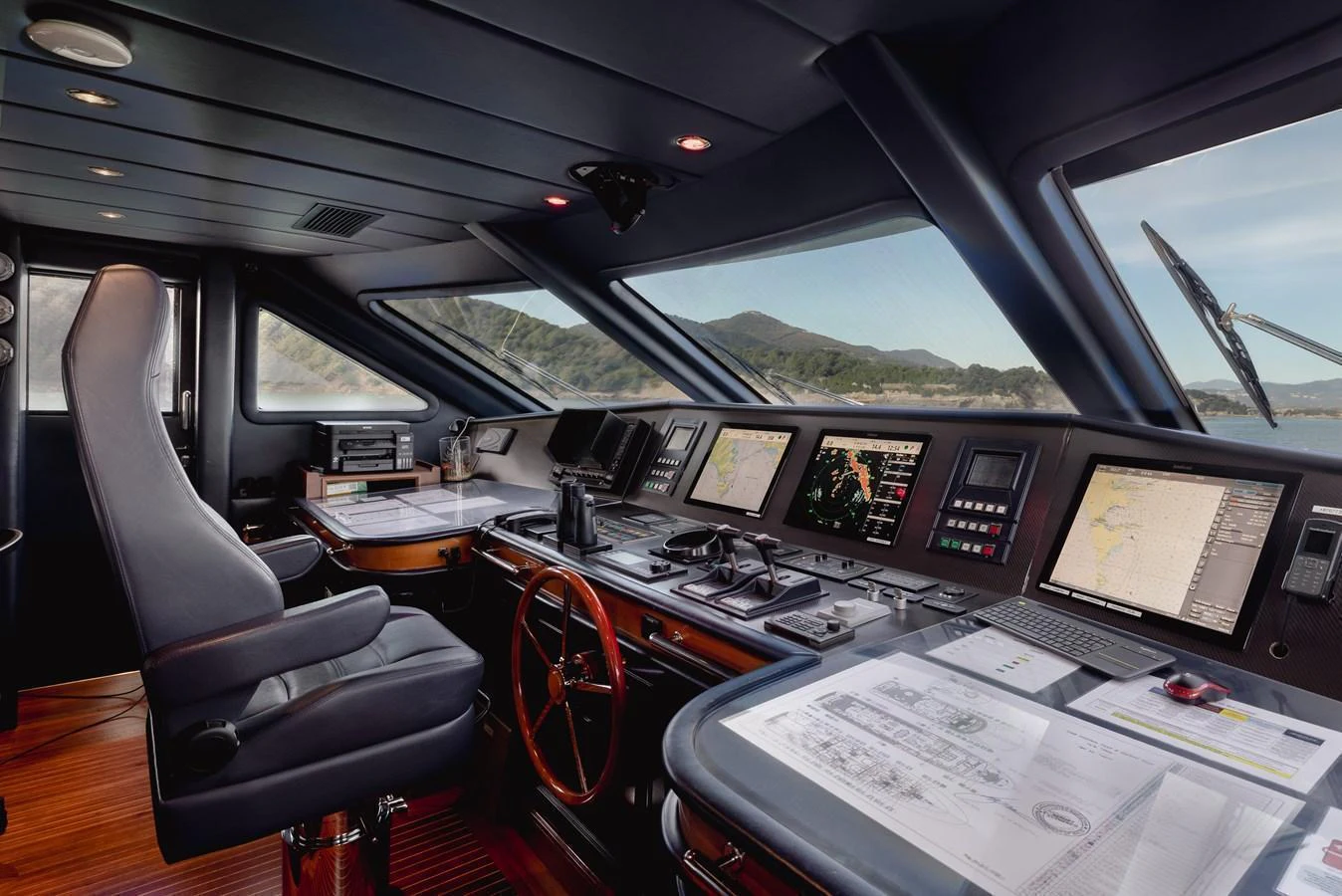 The helm features advanced navigation equipment and a comfortable captain's chair. aboard HOSHI Yacht for Sale