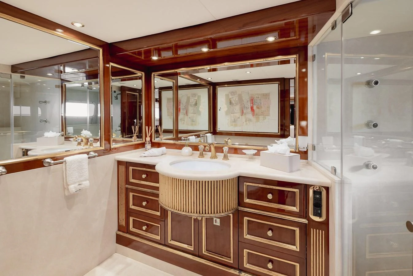 The yacht's bathroom features luxurious wood finishes and elegant fixtures. aboard HOSHI Yacht for Sale