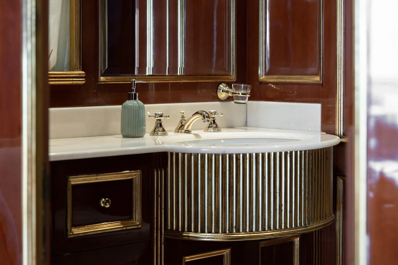 A luxurious bathroom featuring elegant fixtures and rich wood paneling. aboard HOSHI Yacht for Sale