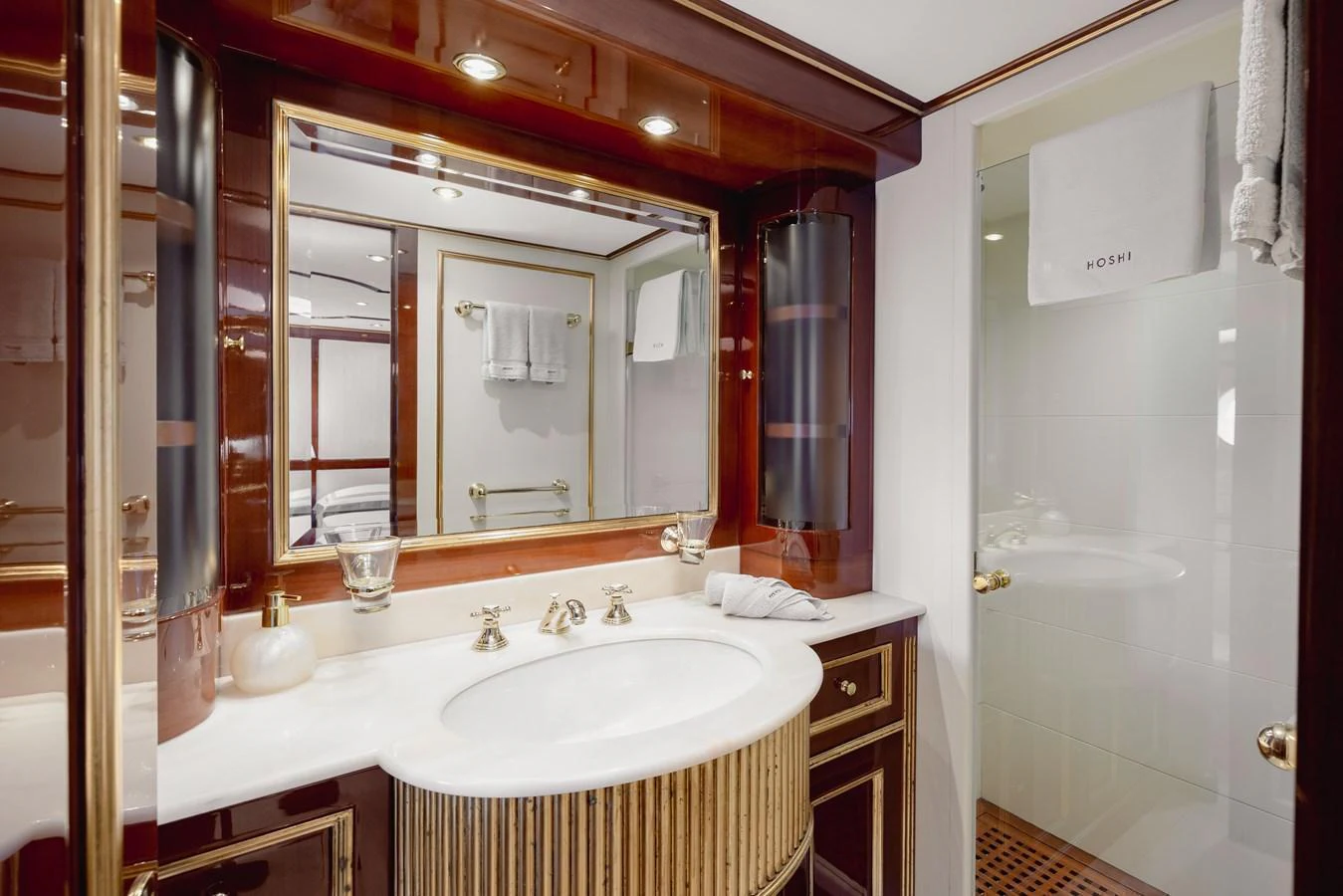 The yacht's bathroom features elegant fixtures and a spacious shower area. aboard HOSHI Yacht for Sale
