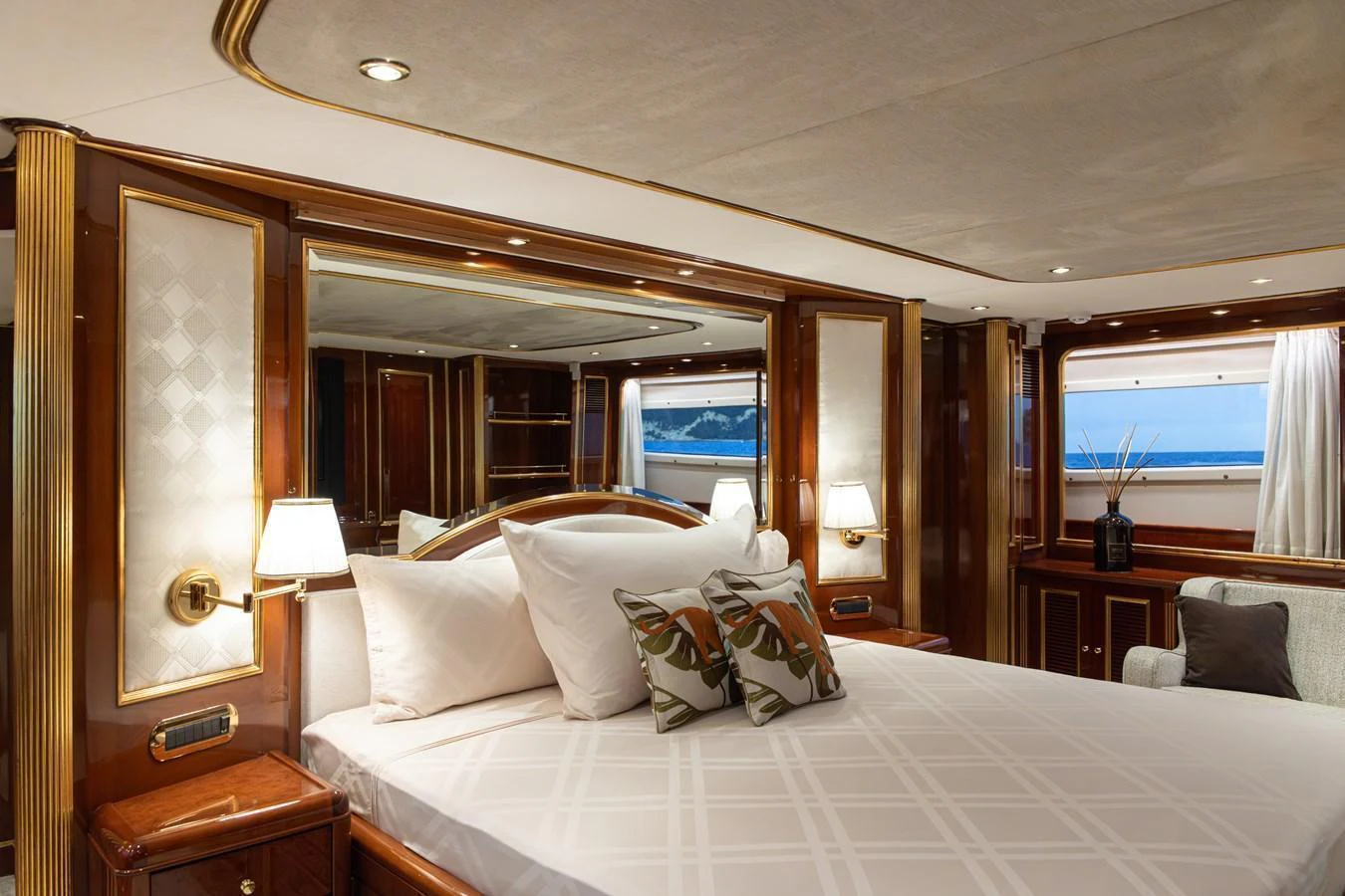 The master stateroom features luxurious bedding and elegant wood finishes, offering a serene retreat. aboard HOSHI Yacht for Sale