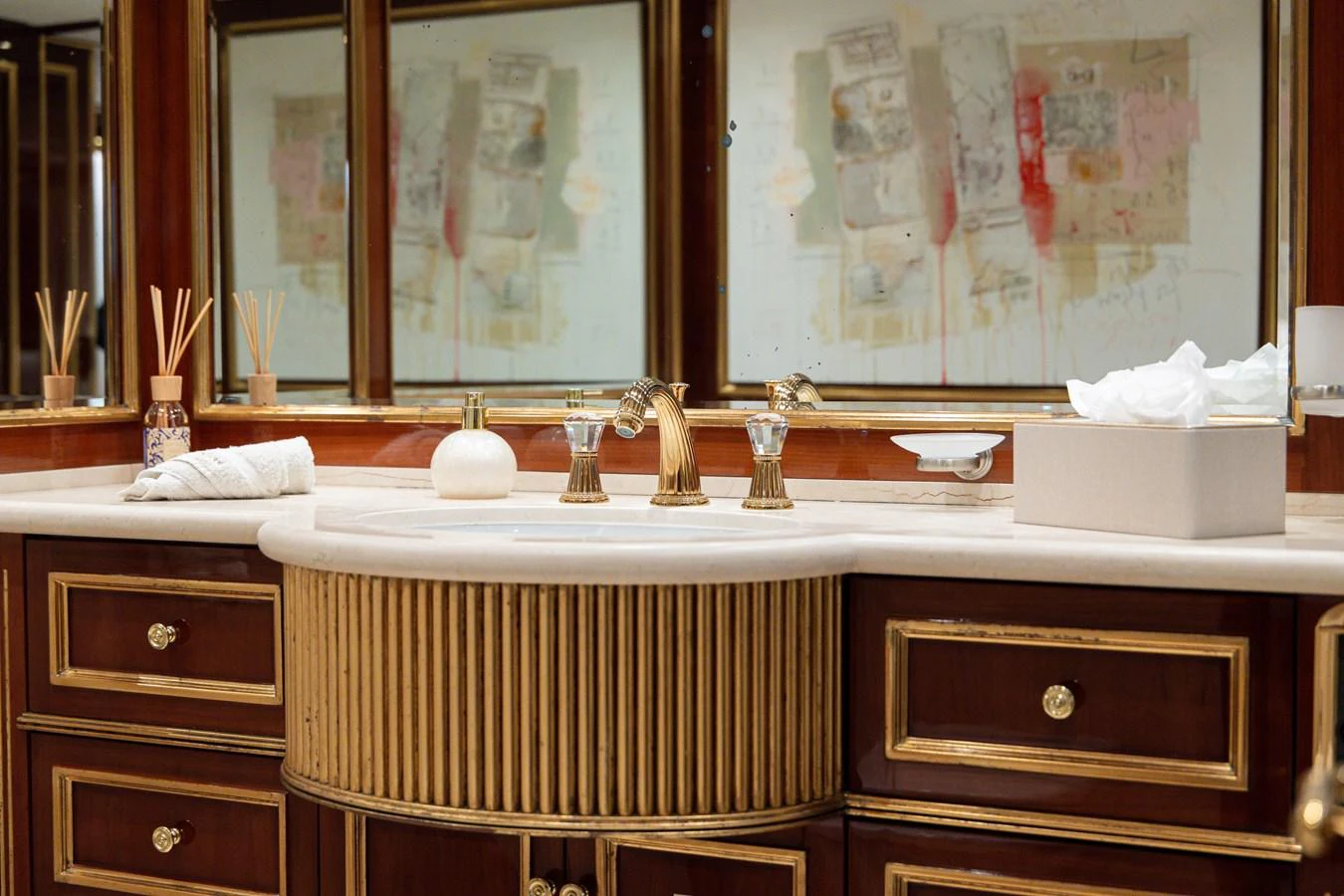 The luxurious bathroom features elegant fixtures and rich wooden cabinetry. aboard HOSHI Yacht for Sale