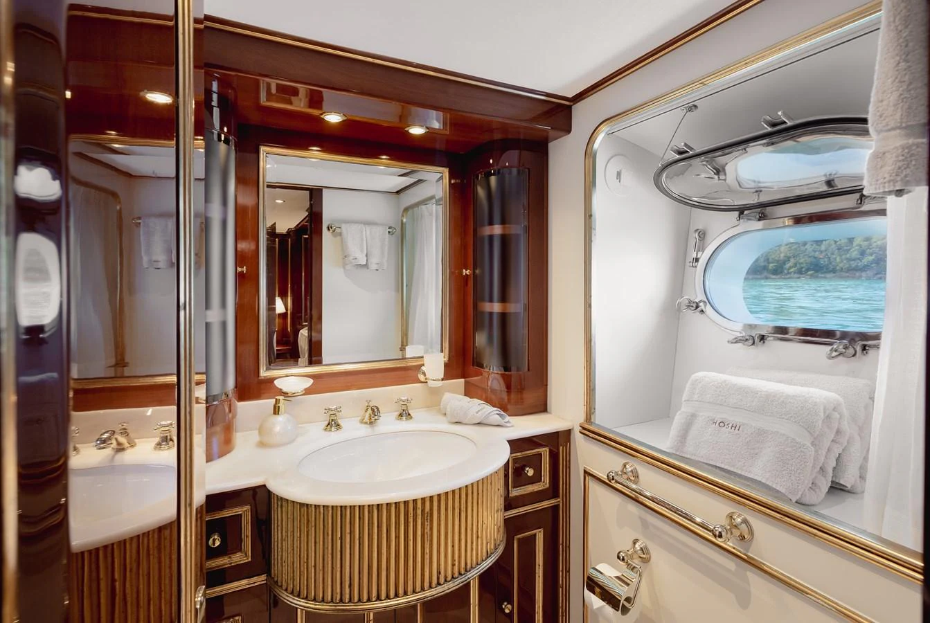 The yacht's bathroom features elegant fixtures and a scenic window view. aboard HOSHI Yacht for Sale