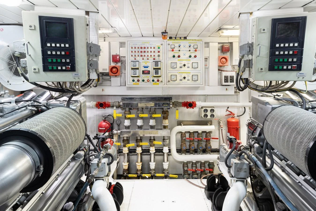 The image showcases the well-maintained engine room with advanced control panels and machinery. aboard HOSHI Yacht for Sale