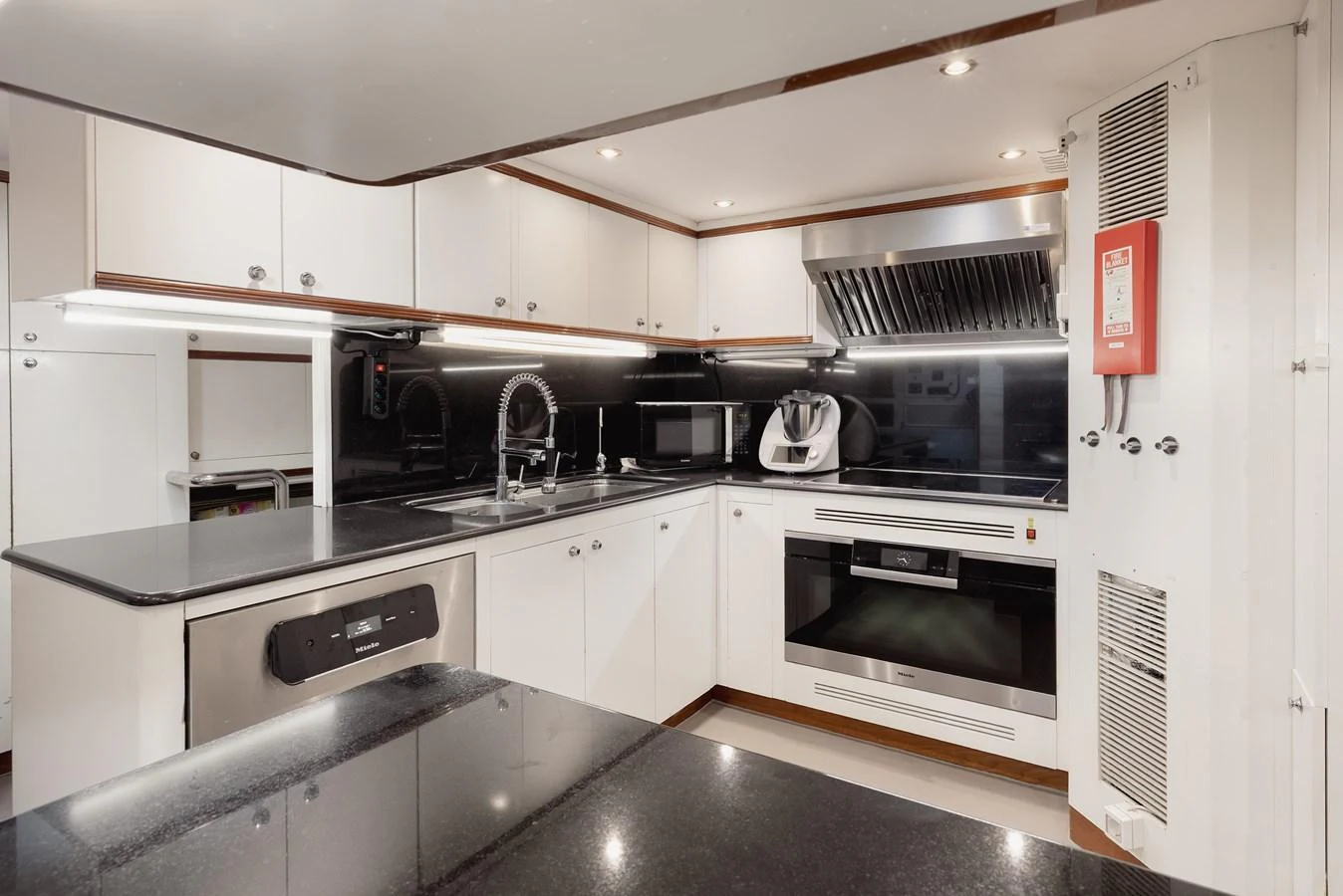 The yacht's galley is equipped with modern appliances and sleek countertops, offering a functional and stylish cooking space. aboard HOSHI Yacht for Sale