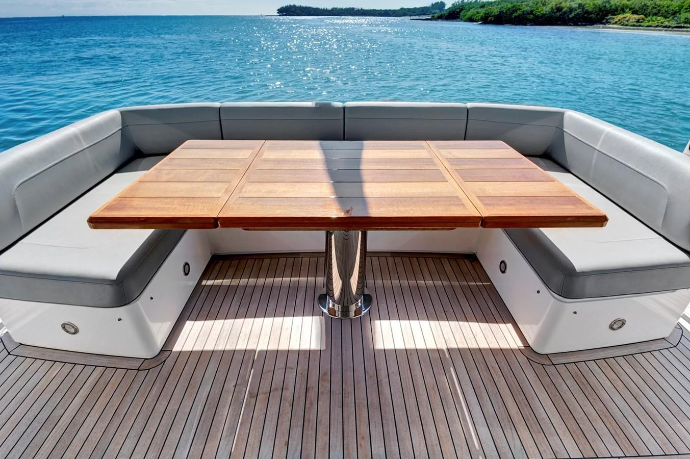 The aft deck features a spacious seating area with a wooden table, perfect for outdoor dining and relaxation. aboard MISTY K Yacht for Sale