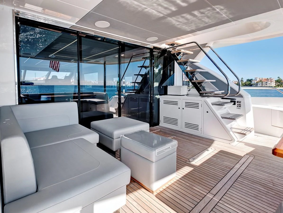 The aft deck features comfortable seating and a staircase leading to the upper deck. aboard MISTY K Yacht for Sale