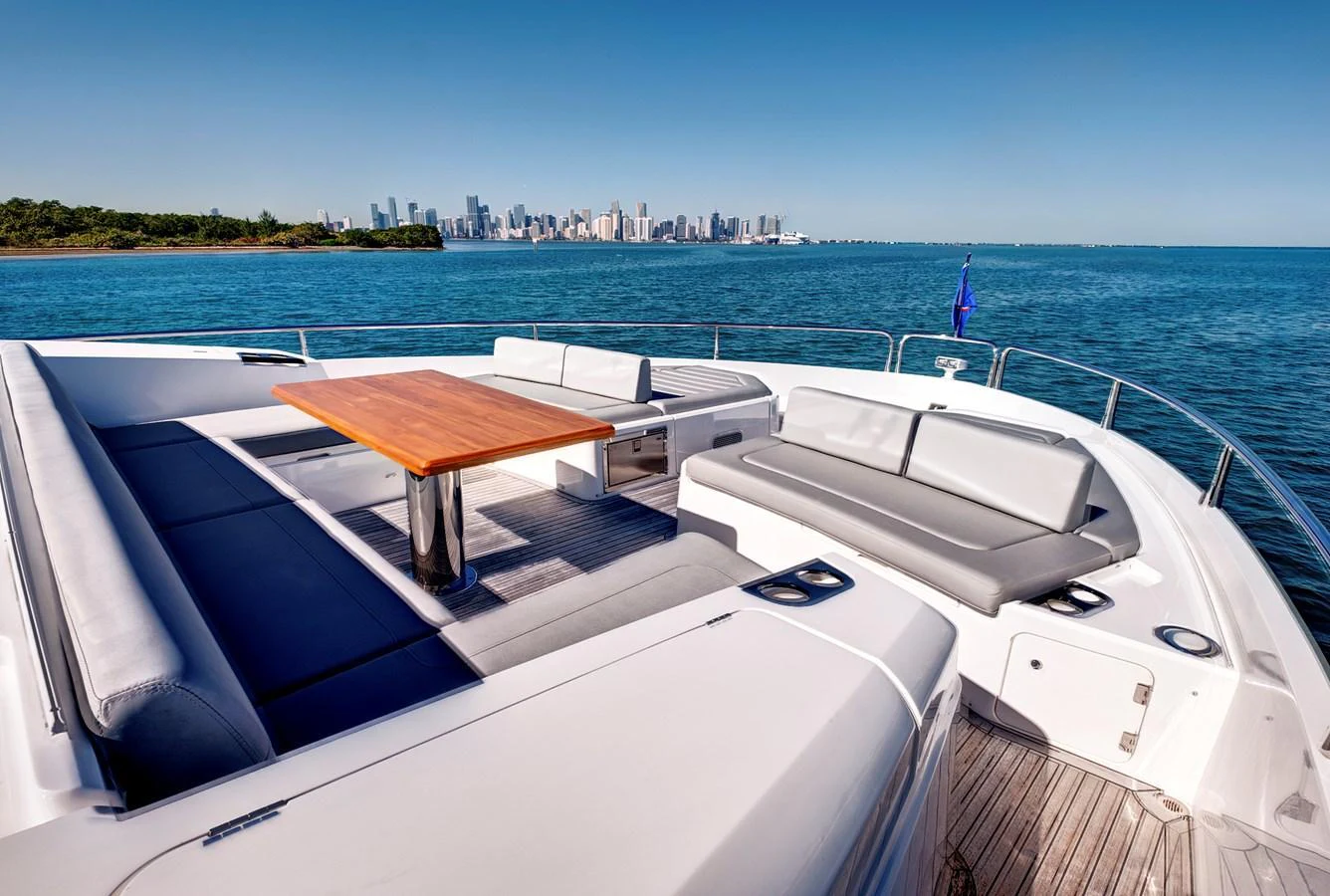 The aft deck offers a spacious seating area with a wooden table, perfect for enjoying the scenic views. aboard MISTY K Yacht for Sale