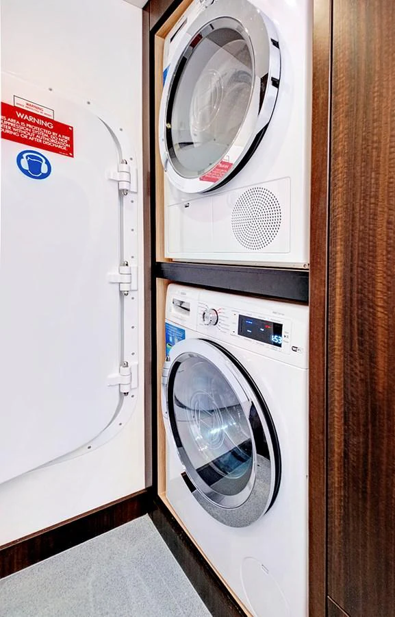 The yacht features a convenient laundry room with modern washer and dryer units. aboard MISTY K Yacht for Sale