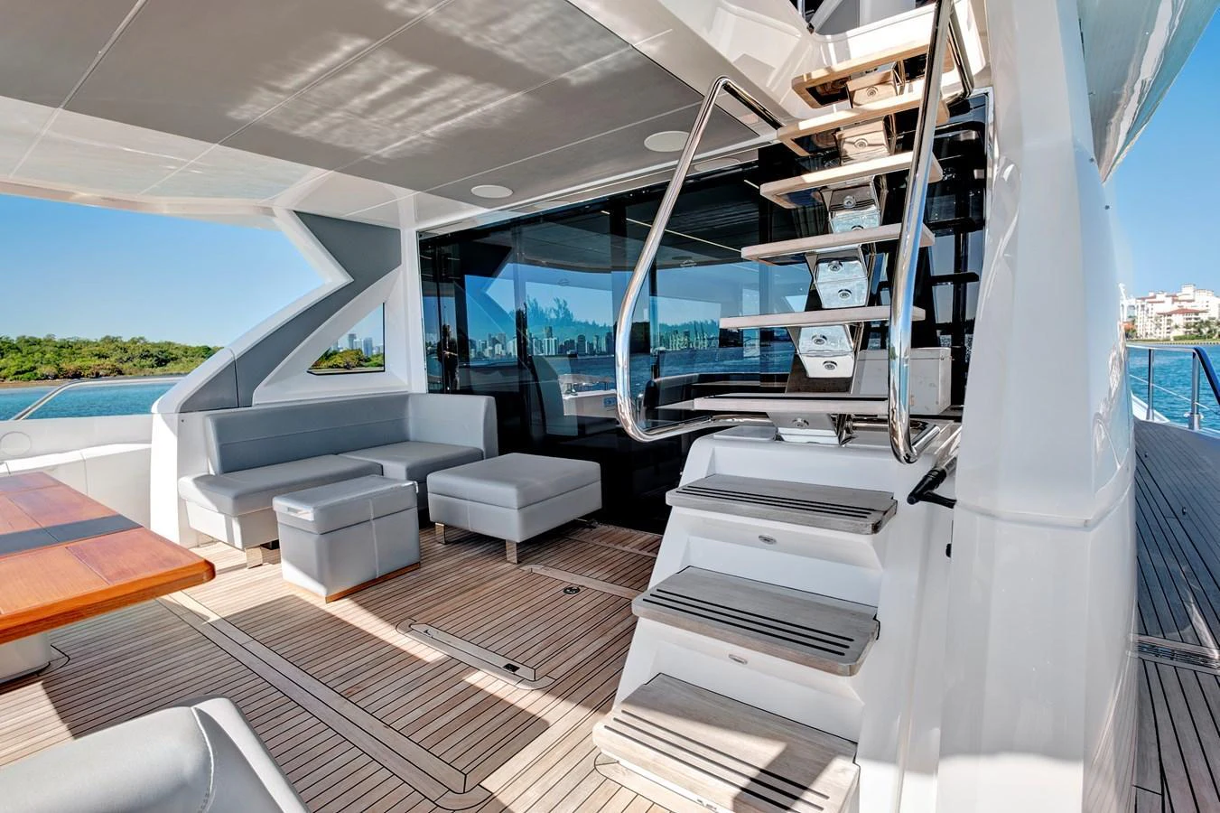 The aft deck features comfortable seating and a stylish staircase leading to the upper deck. aboard MISTY K Yacht for Sale