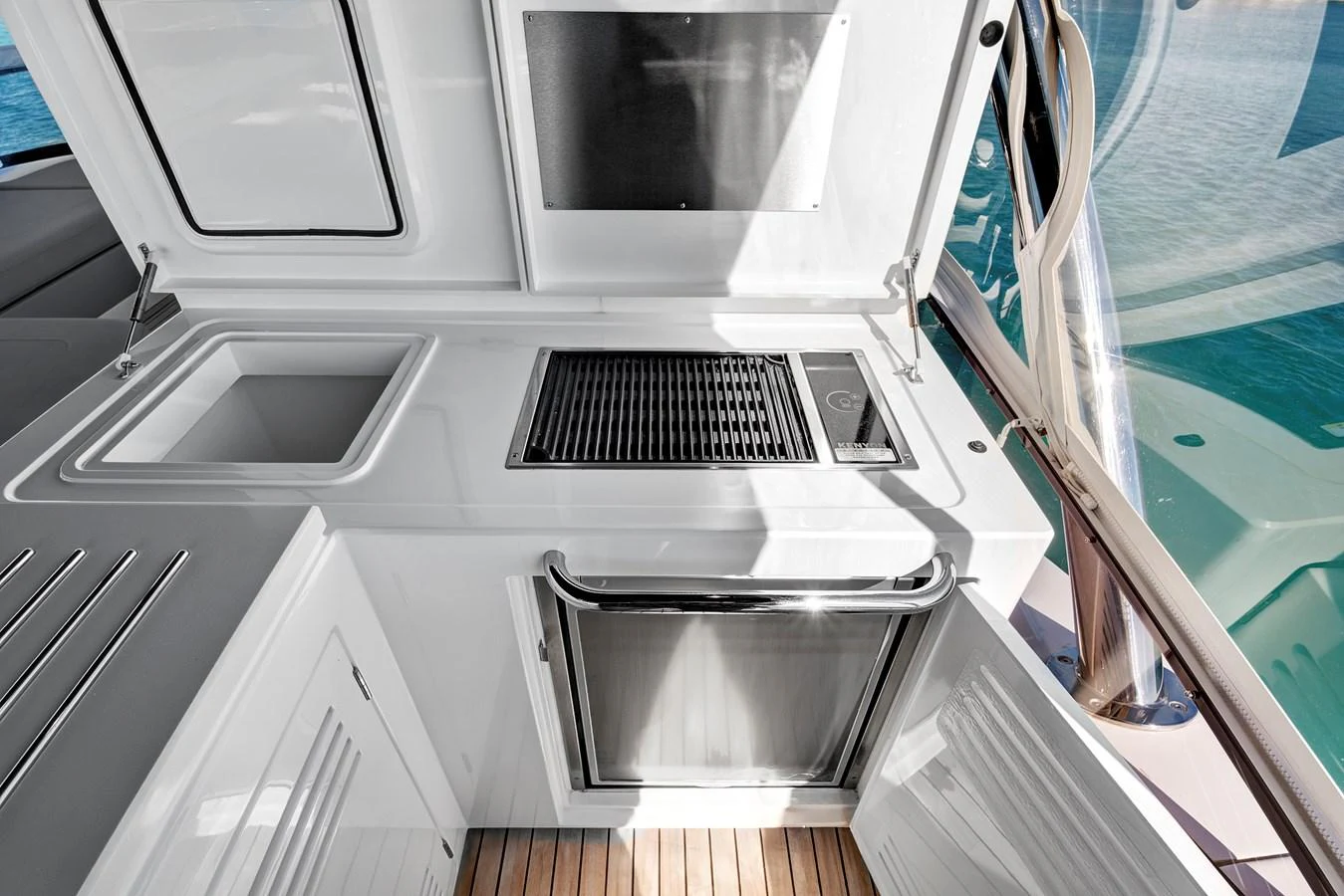 The yacht features a sleek outdoor galley with a grill and sink, perfect for alfresco dining. aboard MISTY K Yacht for Sale