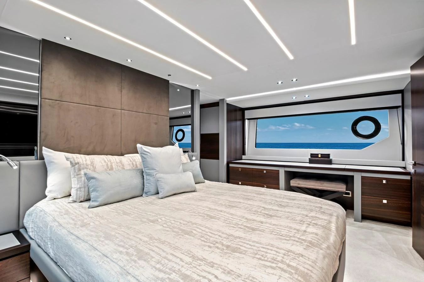 The master stateroom features a luxurious bed with a stunning ocean view through large windows. aboard MISTY K Yacht for Sale